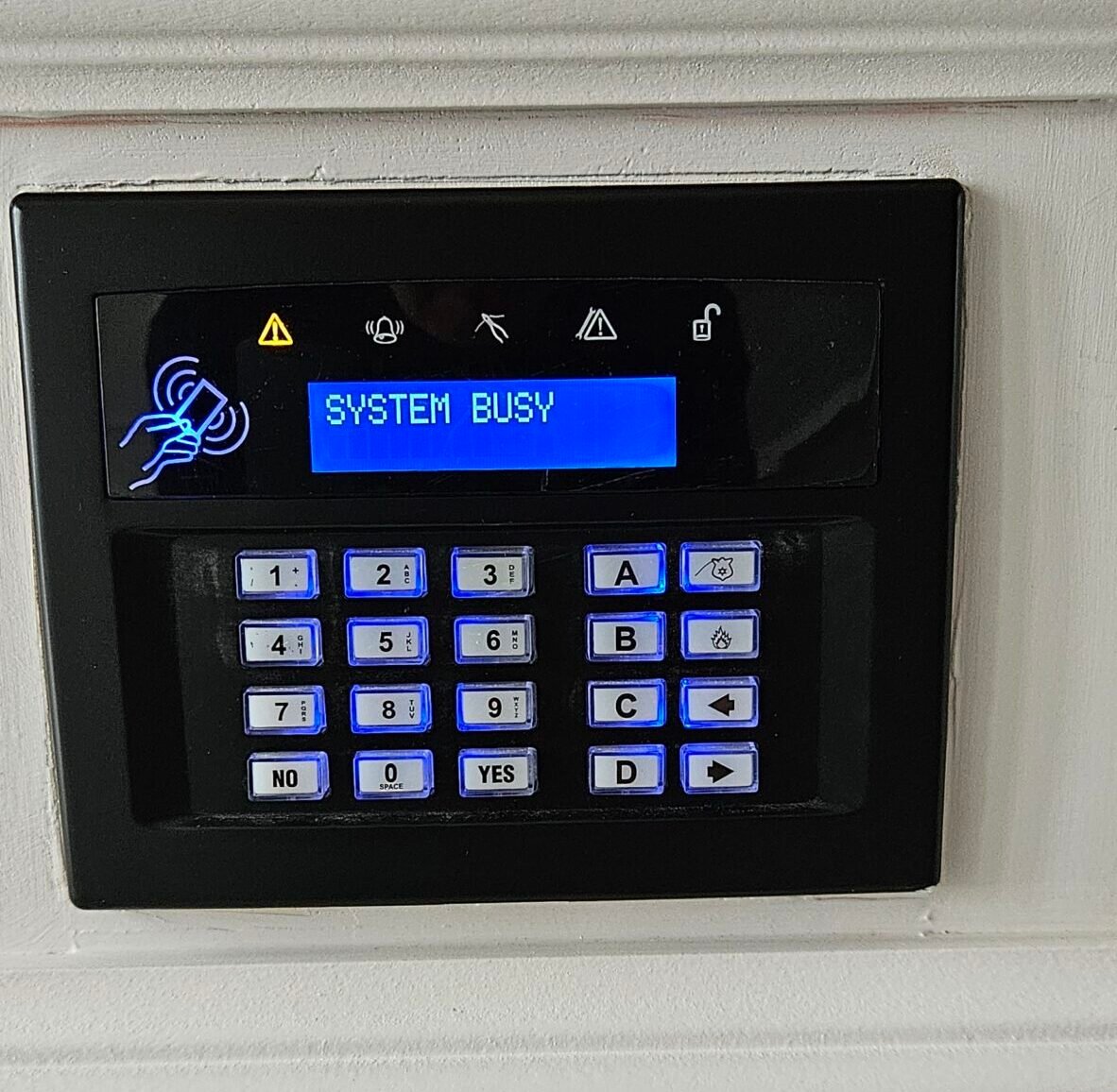 A close-up of a black home security alarm keypad | HOME SECURITY INSTALLATIONS